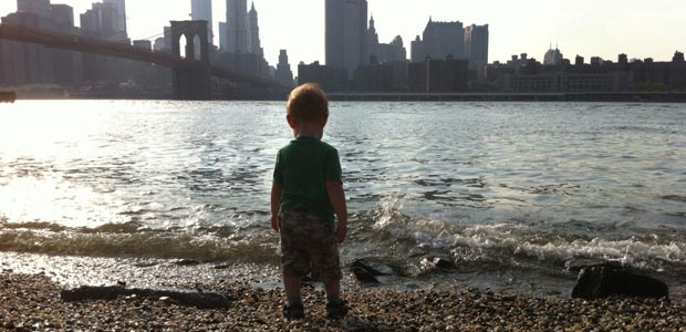 Childfree Green GINK Child overlooks the East River from Brooklyn towards Manhattan
