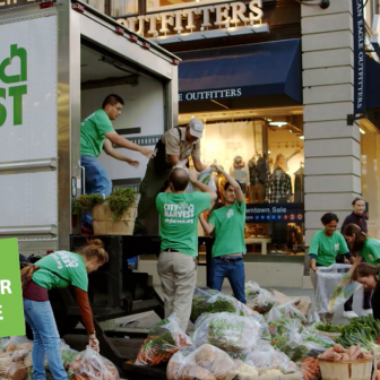 NYC kids load a City Harvest Truck for Food Donation